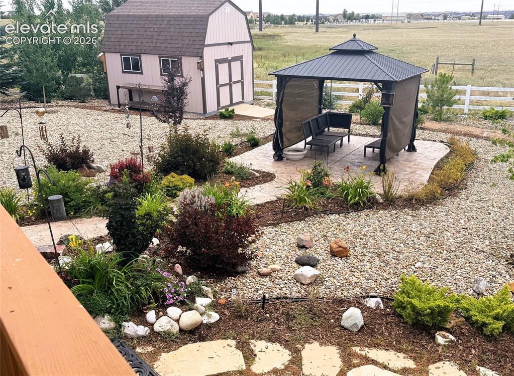 Image 35 of 43: View of Lush Gardens, Gazebo and Shed in Backyard
