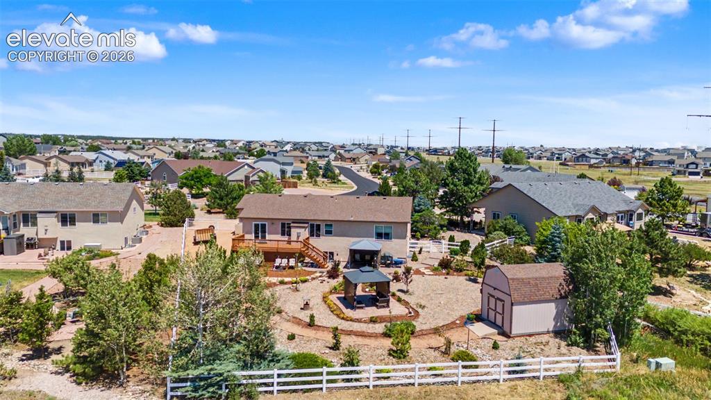 Image 39 of 43: Aerial View of Back of Home and Picturesque Backyard adorned with Lush Land