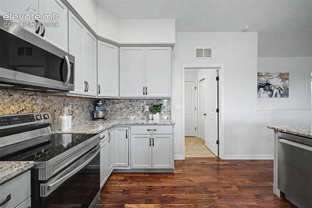 Image 6 of 43: Door off Kitchen includes Laundry Room, Pantry and Door to Garage