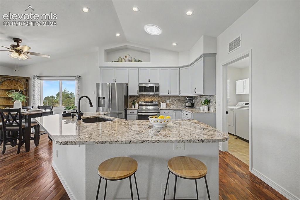 Image 7 of 43: Bright Updated Kitchen with Large Isalnd and Solar Ceiling Tube Light