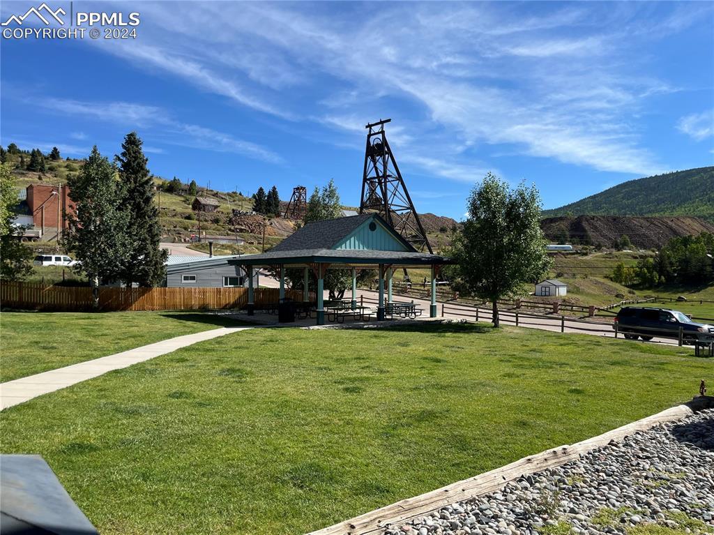 Image 2 of 12: Surrounding community featuring a gazebo, a mountain view, and a yard
