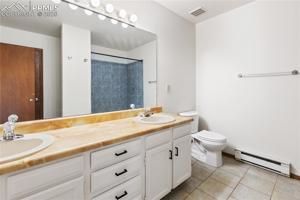 Image 15 of 27: The main bathroom features a double sink vanity!