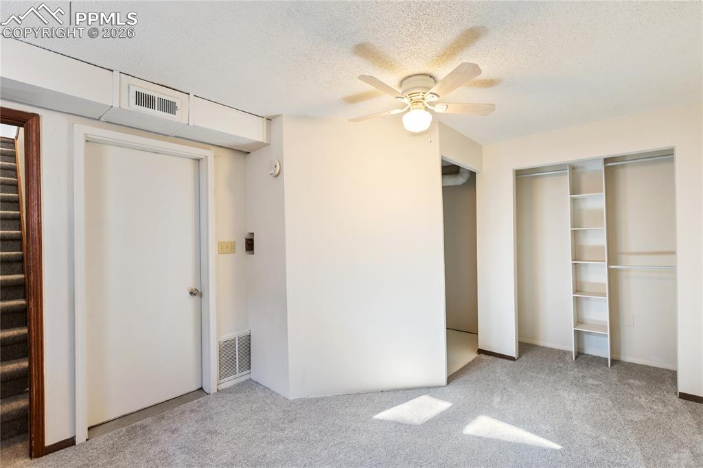 Image 19 of 27: Unfurnished bedroom with light colored carpet, a textured ceiling, ceiling 