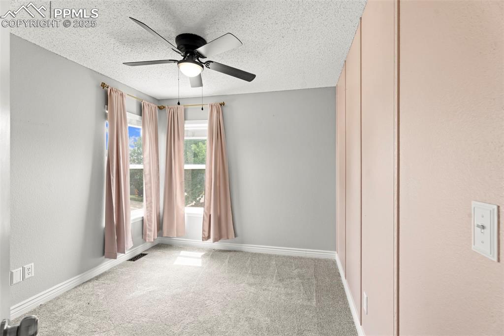 Image 17 of 30: Carpeted spare room with a textured ceiling, a textured wall, and a ceiling