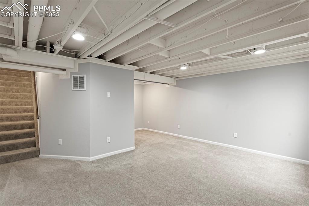 Image 19 of 30: Finished basement featuring carpet flooring and baseboards