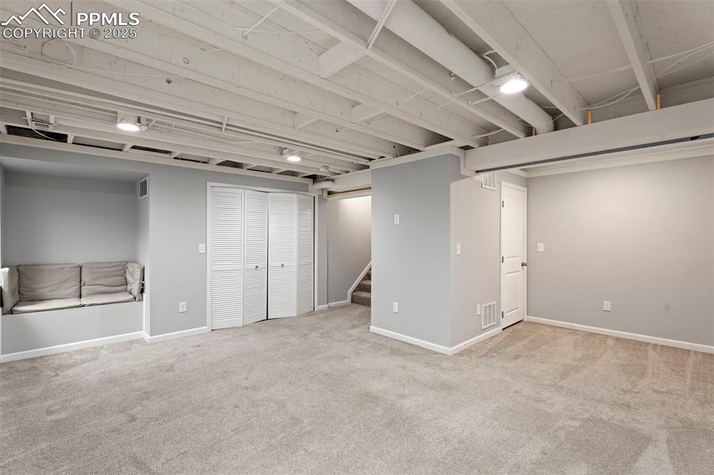 Image 20 of 30: Finished below grade area featuring stairs and carpet floors