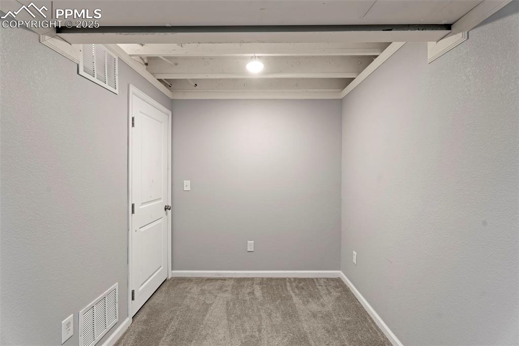 Image 21 of 30: Empty room with light colored carpet and a textured wall