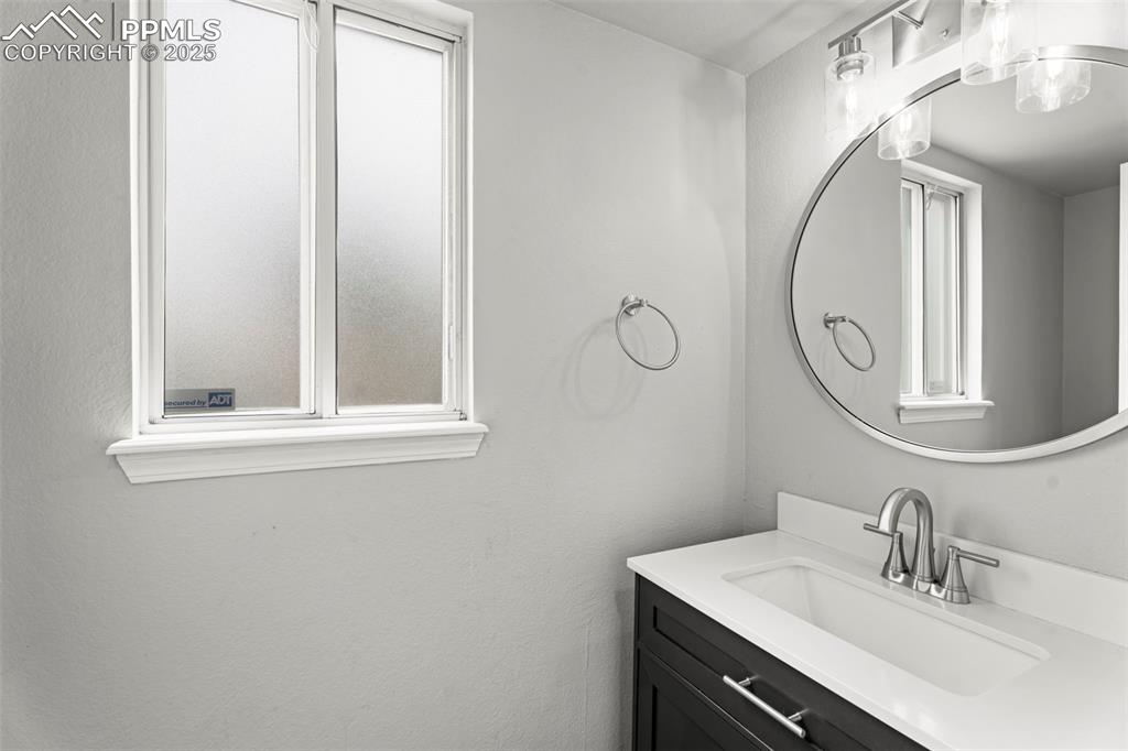 Image 22 of 30: Bathroom featuring vanity and a textured wall