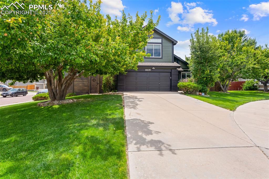 Image 3 of 30: Obstructed view of property with a garage and driveway