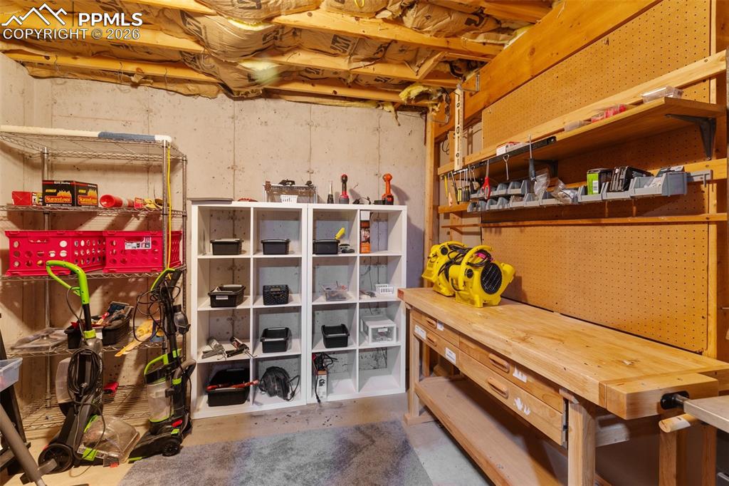 Image 28 of 30: Utility space featuring exposed ceiling joists, concrete foundation walls, 