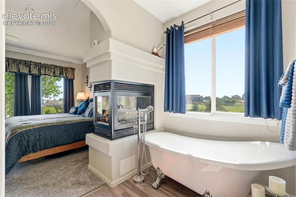 Image 15 of 48: 3 sided fireplace next to your clawfoot tub
