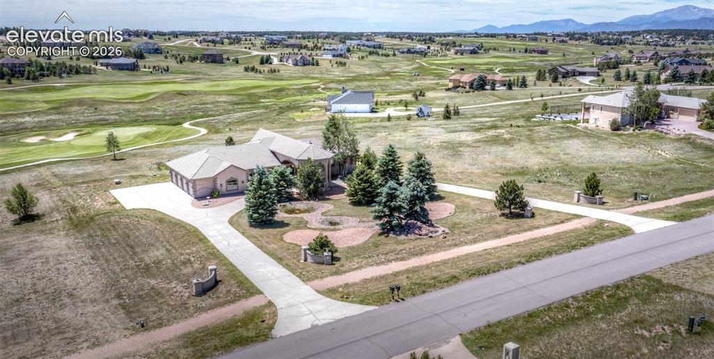 Image 41 of 50: Sprawling residence featuring a multi-car garage, extensive concrete drivew