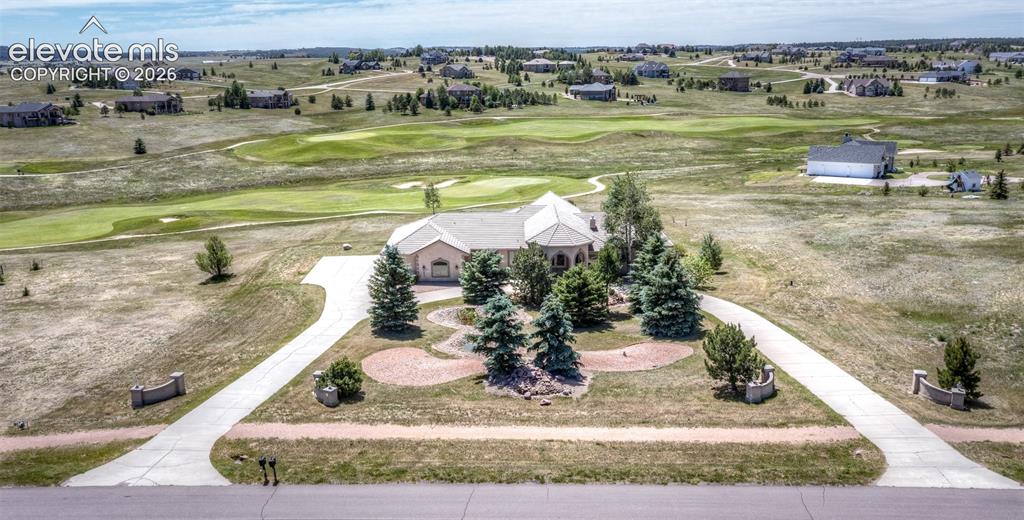 Image 42 of 50: Spacious property featuring a golf course, mature trees, and an extensive p