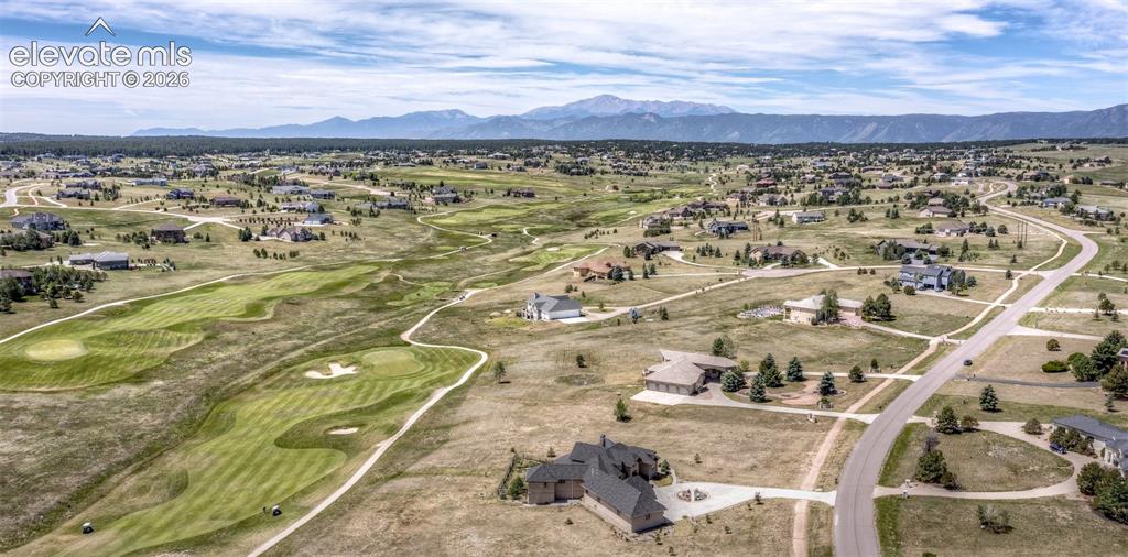 Image 50 of 50: Expansive aerial perspective showcasing a residential community with distan
