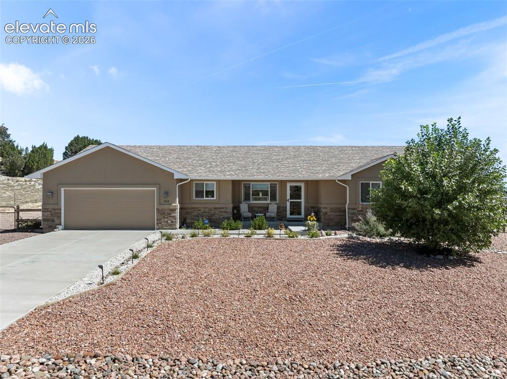Image 1 of 21: Single-story residence featuring stucco and stone veneer facade, attached g