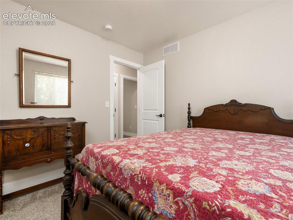 Image 13 of 21: Neutral wall color, carpet flooring, and white trim
