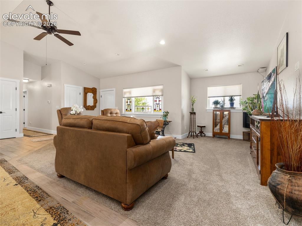 Image 3 of 21: Vaulted ceiling with a ceiling fan, recessed lighting, wood-finish flooring