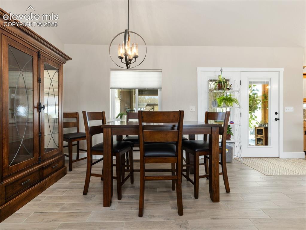 Image 6 of 21: Wood-finish flooring, built-in display cabinetry, double French doors, and