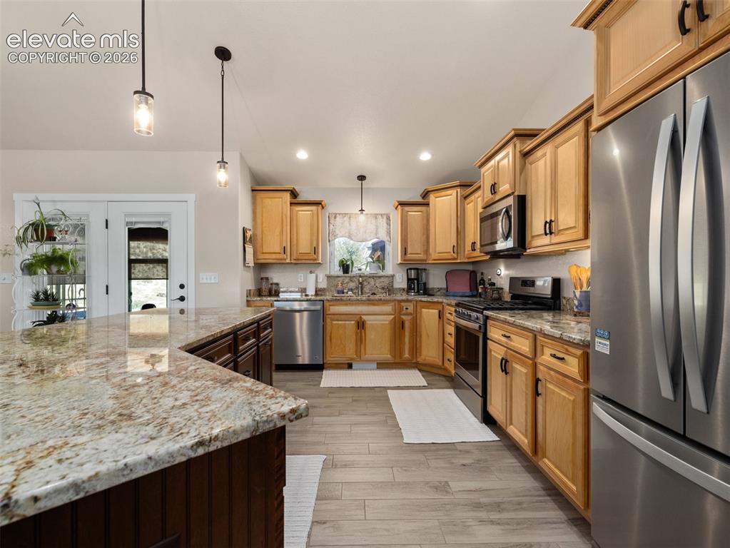Image 8 of 21: Kitchen featuring light wood-finish cabinetry, stainless steel appliances, 