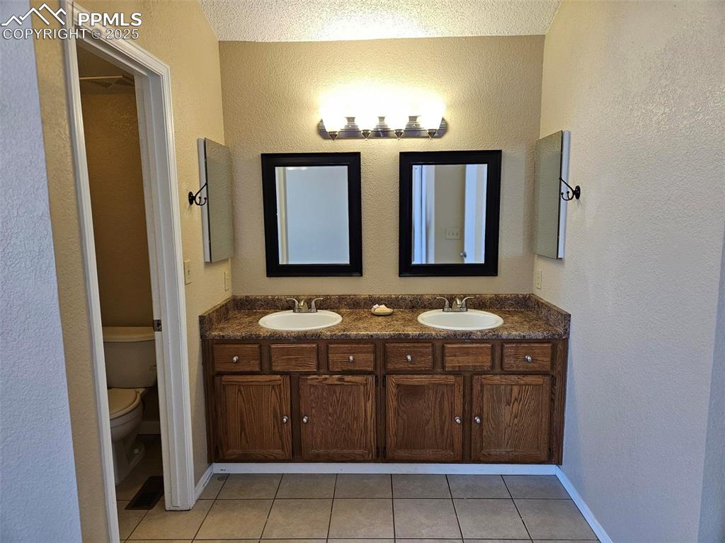 Image 13 of 27: Primary bathroom double vanity
