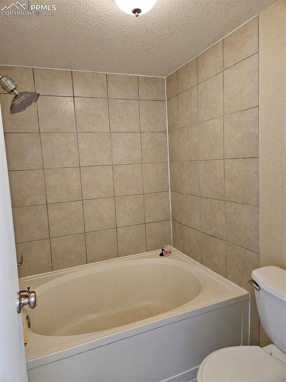 Image 14 of 27: Shower/soaker tub in primary bedroom