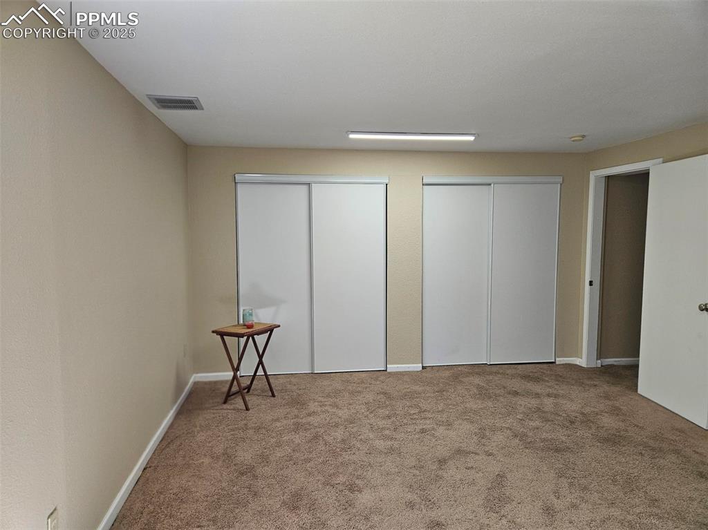 Image 17 of 27: Basement Family Room with storage closets