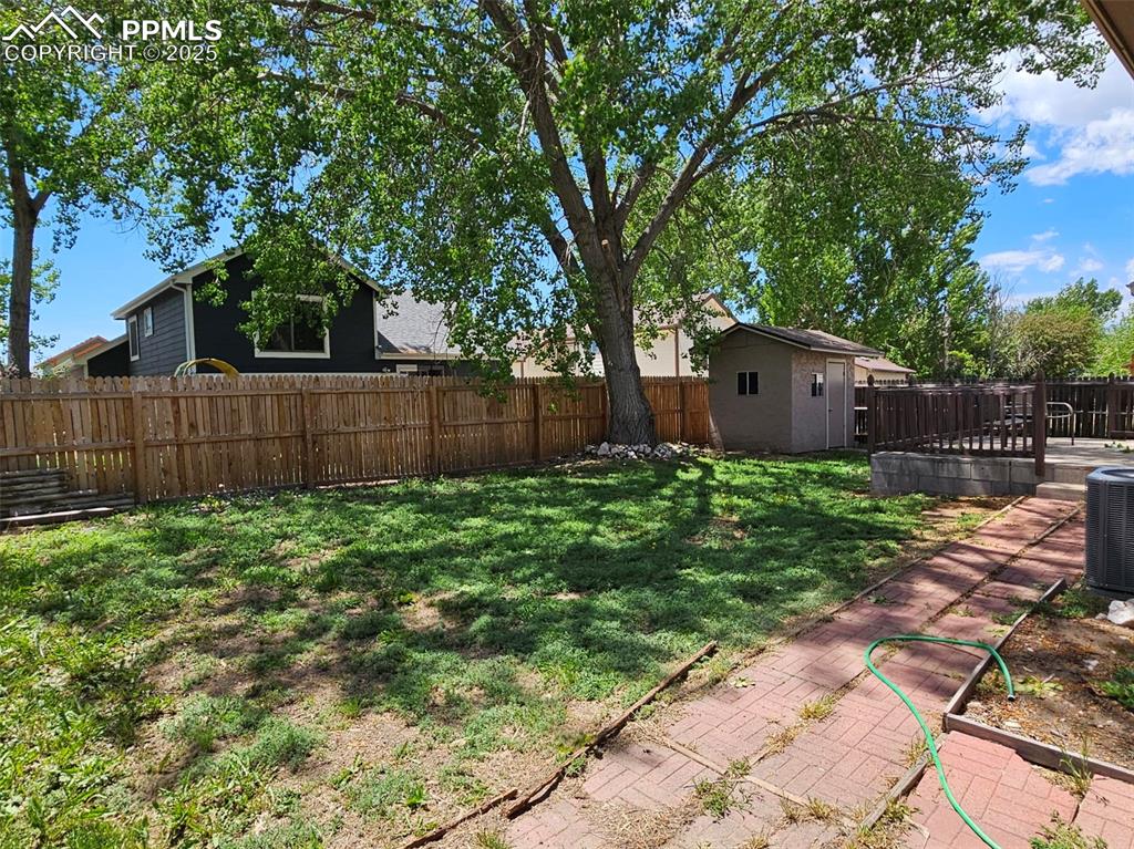 Image 25 of 27: Backyard w/AC condenser