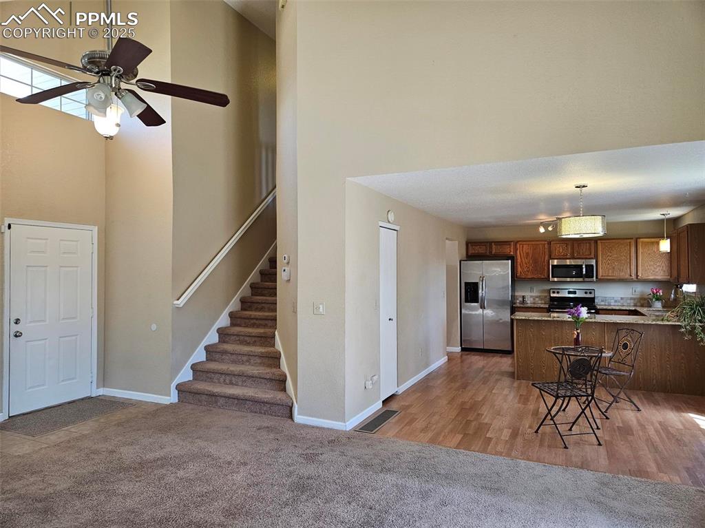 Image 4 of 27: View from living room to dining area and kitchen