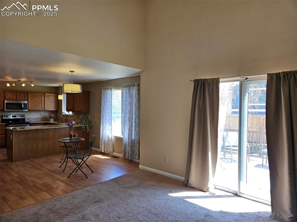 Image 5 of 27: Open living dining area with walk out to back patio and yard