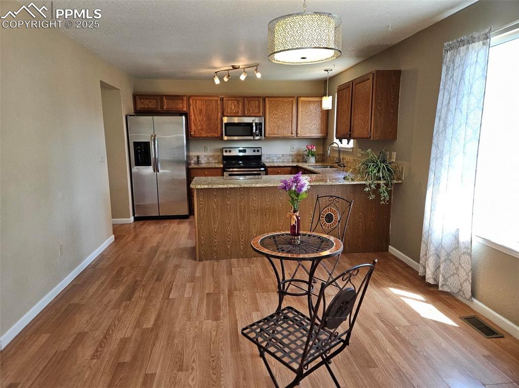 Image 6 of 27: Kitchen featuring appliances, cabinets, adjoining dining area