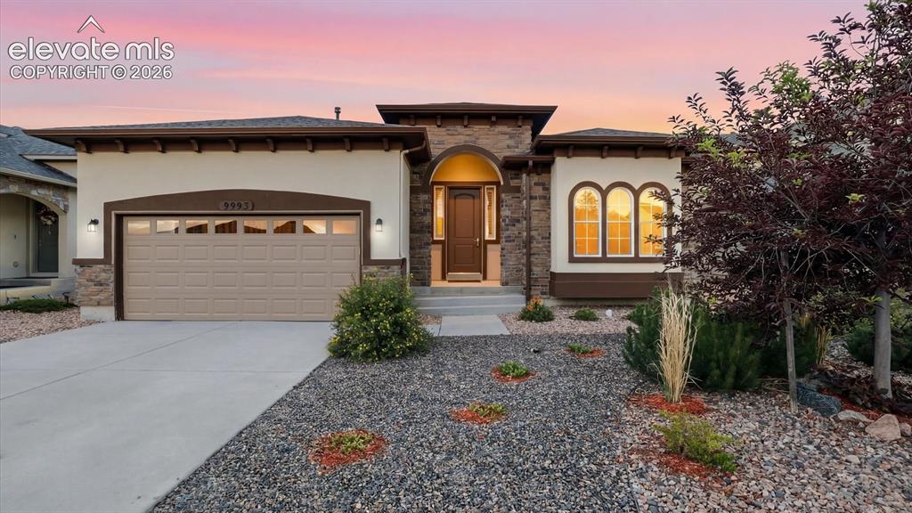 Image 10 of 50: Outstanding curb appeal, featuring low-maintenance landscaping, mature tree