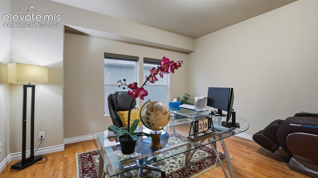 Image 15 of 50: A versatile flex room, accessed through French doors, can serve as a home o