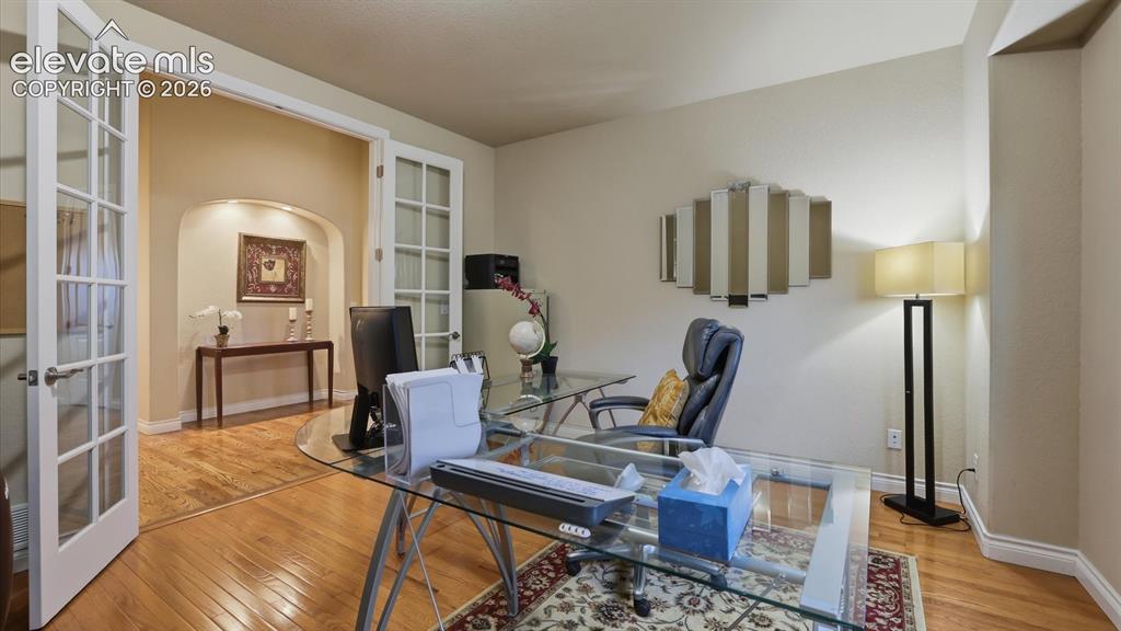 Image 16 of 50: French doors lead into the main level Flex Room (currently an office)