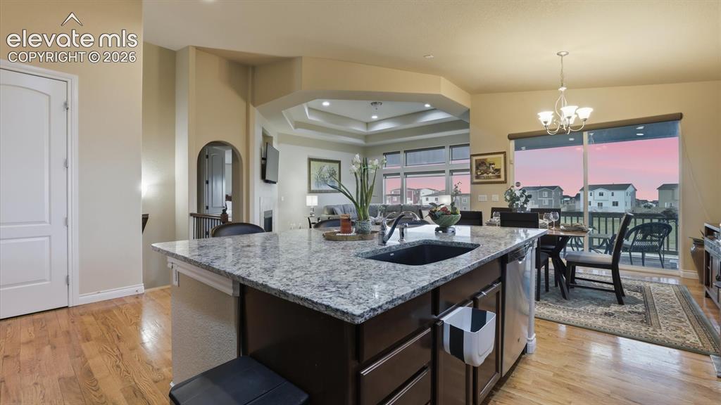 Image 19 of 50: View of the Living Room and Dining Area from the Kitchen.
