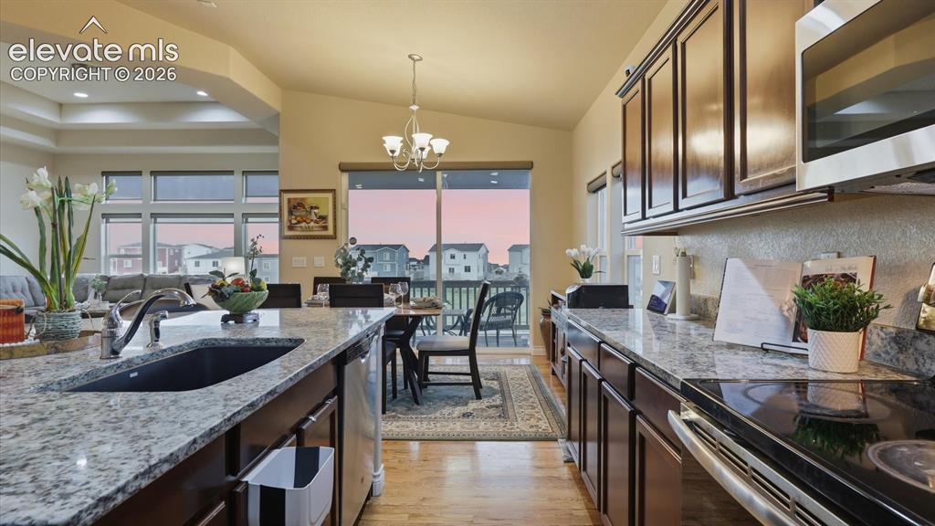 Image 20 of 50: View of the Dining Area from the Kitchen and slider door to a covered deck.