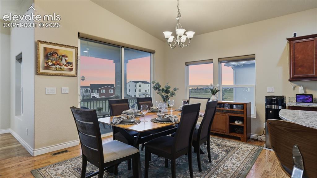 Image 21 of 50: The dining area opens onto a covered wood deck, perfect for taking in sceni