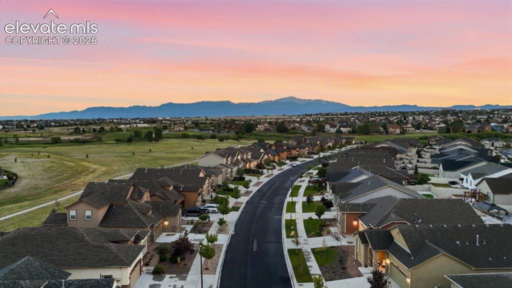 Image 3 of 50: Aerial view of home and neighborhood with gorgeous mountain views.