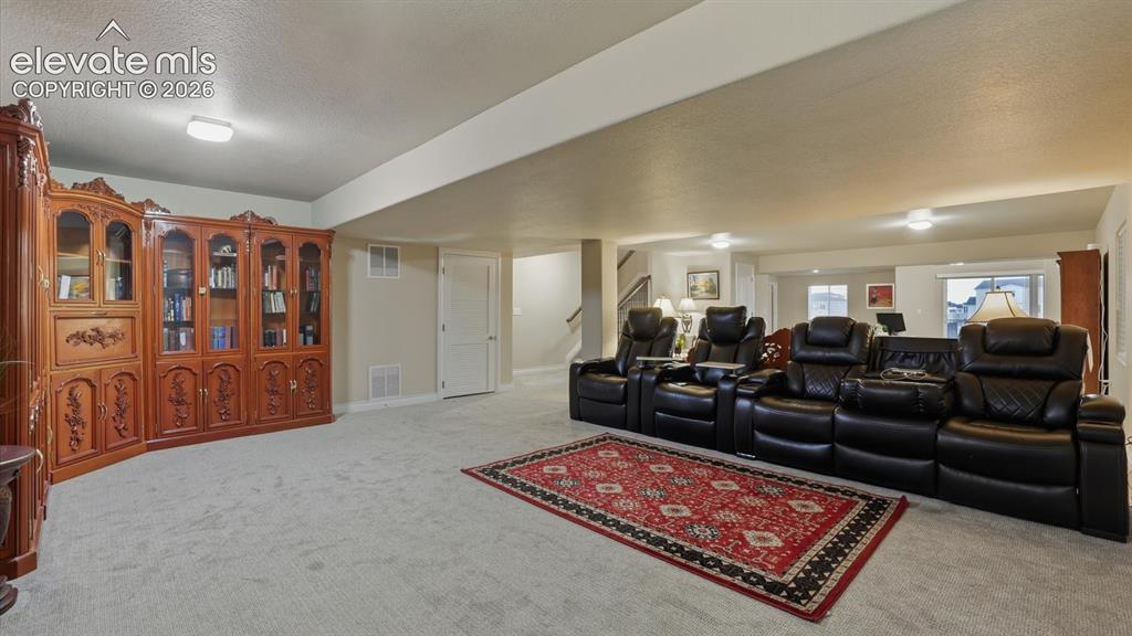 Image 39 of 50: Basement Family Rec Room with neutral carpet.