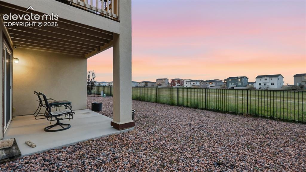 Image 42 of 50: Covered patio with views of open space that include walking/biking trails.