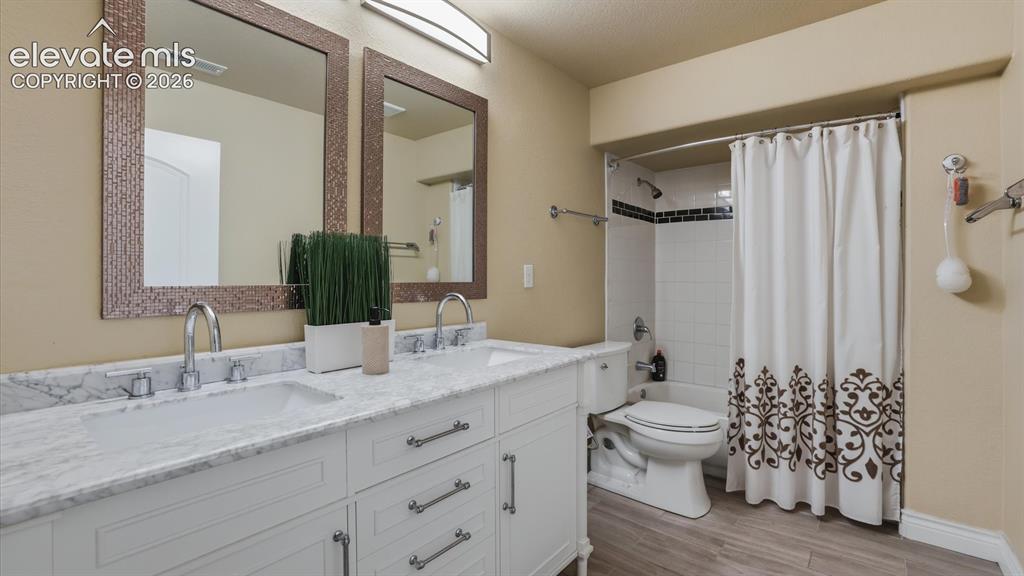 Image 44 of 50: Basement Bathroom with an expansive vanity with dual sink vanity, framed mi