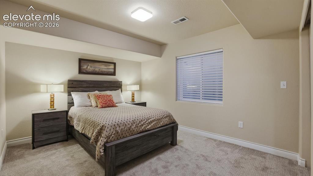 Image 45 of 50: Basement Bedroom #3 with neutral carpet.