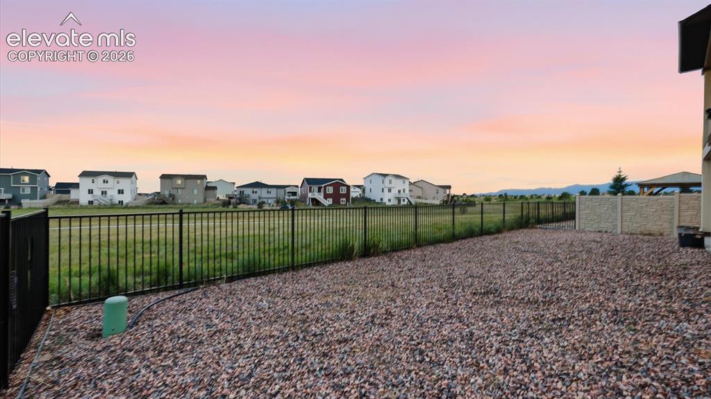 Image 50 of 50: Backyard overlooking open, green space with walking/biking trails.