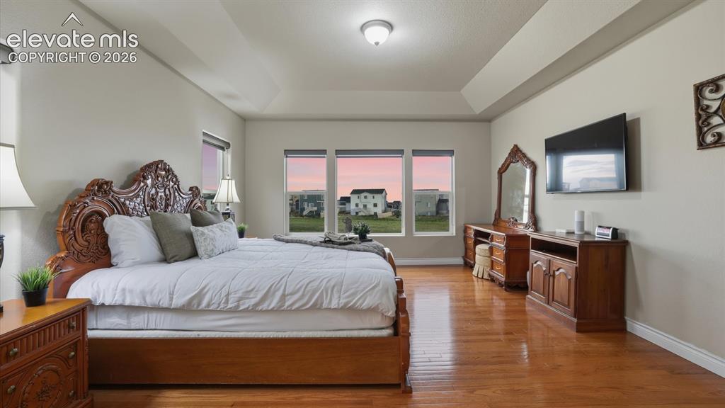 Image 6 of 50: The Primary Bedroom is a spacious retreat with a wall of windows, adjoining