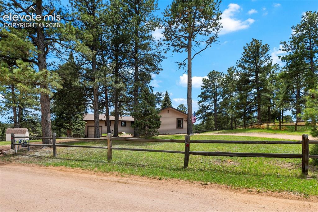 Image 2 of 36: Ranch-style residence featuring a two-car garage and a light-colored exteri