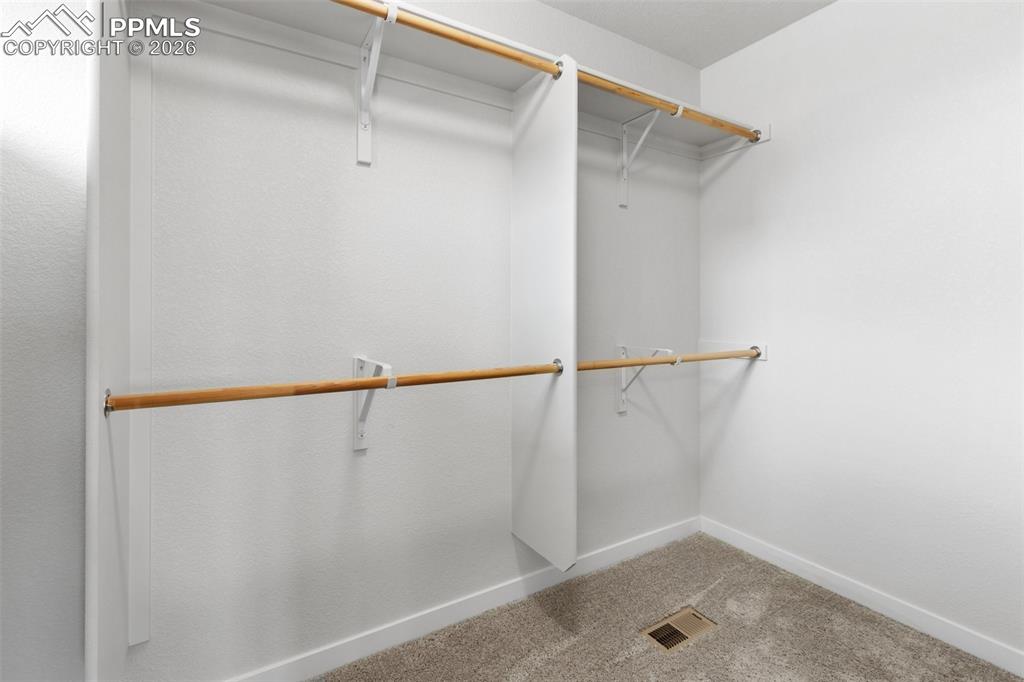 Image 28 of 46: Spacious walk-in closet with ample storage