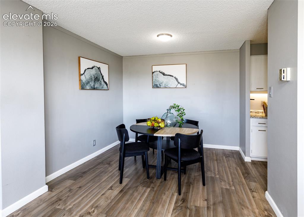 Image 6 of 12: Wood-finish flooring, light gray wall tones, and recessed lighting illumina
