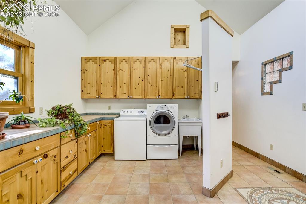 Image 15 of 45: The oversized main-level laundry room offers exceptional storage and functi