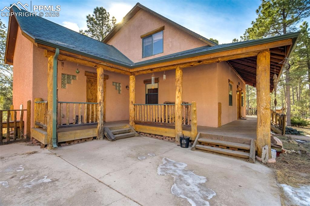 Image 4 of 45: Wrap around porch, this side door enters into mud room and laundry room