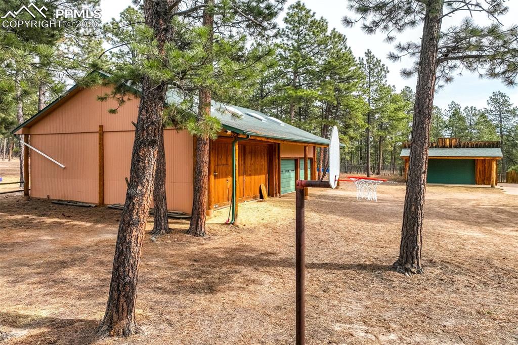 Image 6 of 45: This is the 1st detached garage and huge barn area. Room for a tractor, toy
