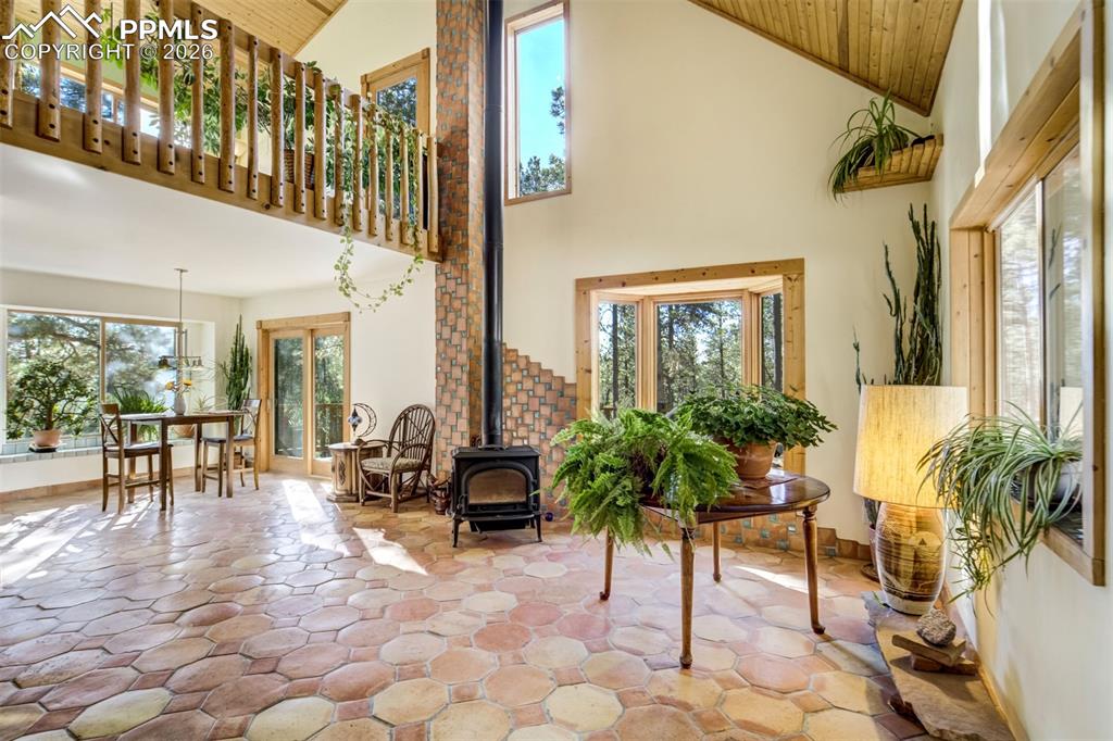 Image 7 of 45: The home features an open layout with vaulted ceilings, generous windows, a